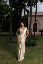 Exquisite ivory drape saree with floral accents, sparkling beads, and elegant bridal charm