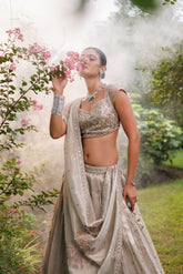 Pastel Beige lehenga with floral detailing, sparkle, and intricate beadwork for a graceful bridal look.