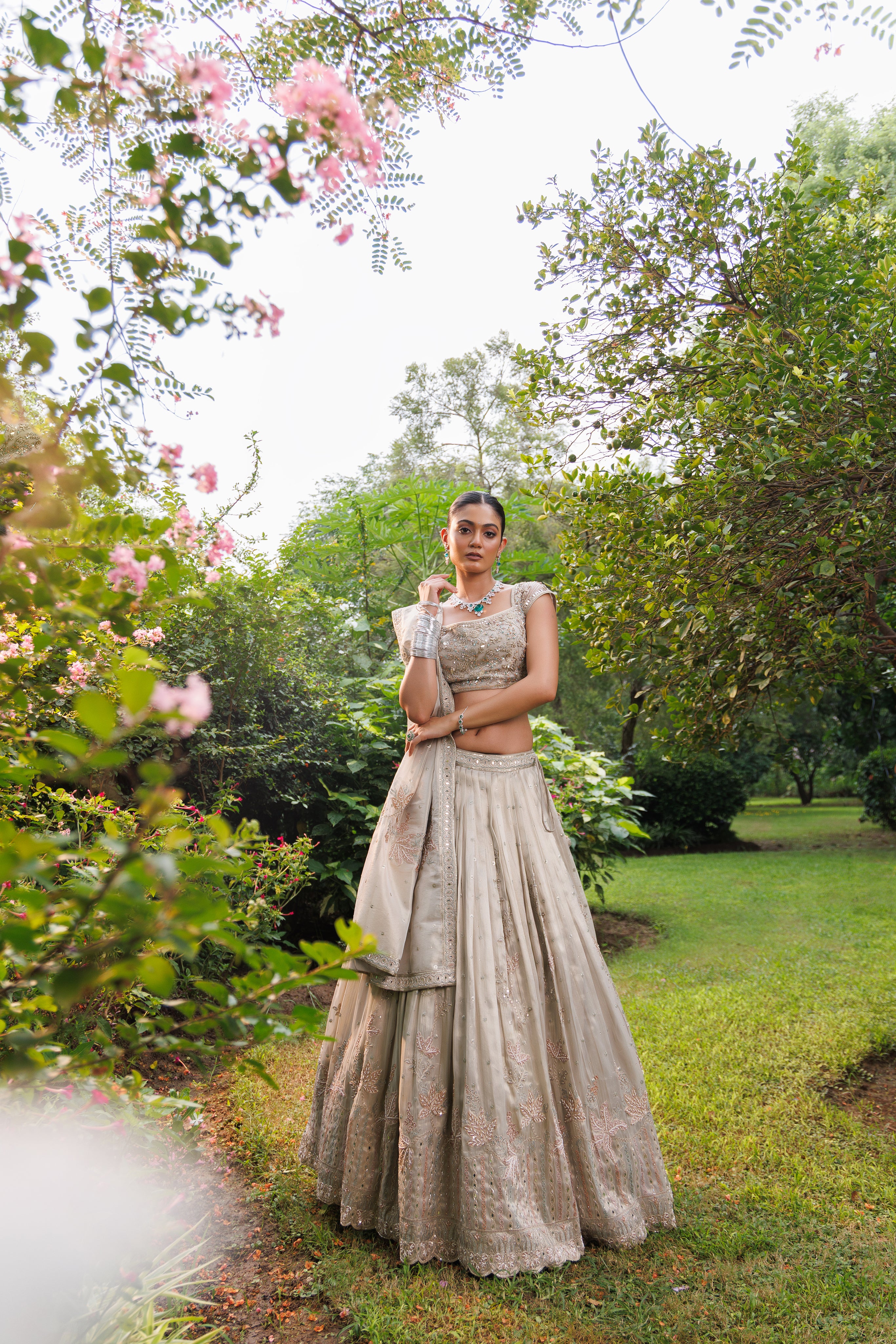 Pastel Beige lehenga with floral detailing, sparkle, and intricate beadwork for a graceful bridal look.