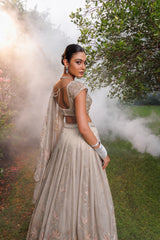 Pastel Beige lehenga with floral detailing, sparkle, and intricate beadwork for a graceful bridal look.